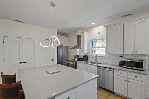 Whether you're meal prepping or hosting, this oversized island and sunny kitchen make it a joy to spend time in.