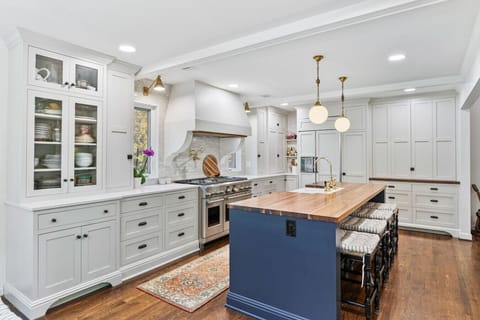 Recently updated state-of-the-art kitchen with a gas range, farm sink, all the dishware and appliances you might need, and seating for four at the kitchen counter.