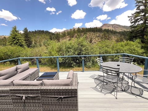 Soak in the serene forest views and mountain skyline from your private furnished deck