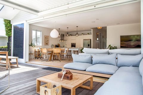 Outdoor living at its best. The bifold doors open up to reveal two more living spaces. There is an outdoor dining room and lounge that fits perfectly with the landscaped backyard. You get the benefit of a top-knotch designer and architect.