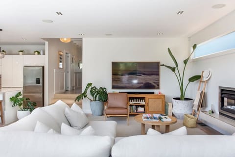 The open plan living area contains the dining room, living room and designer kitchen. All of this is part of the new bump out that has been added to this home to give it  the modern open plan living that we love!