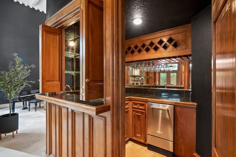 Mini Bar Haven: Sip and savor at this stylish bar with elegant wooden accents and glassware display!