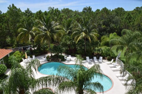 Steps to heated pool and spa - plenty of lounge chairs, tables, and umbrellas