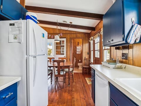Functional galley kitchen with modern appliances and open sightlines to the dining and living areas.
