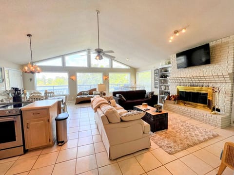 Main level living, kitchen and dining area on the main level with floor to ceiling windows overlooking Weiss Lake