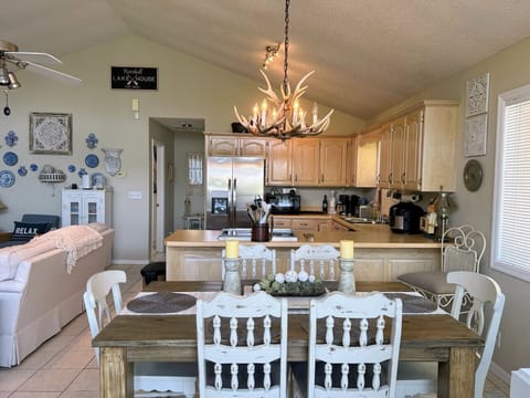 Fully stocked kitchen and dining area with stainless steel appliances