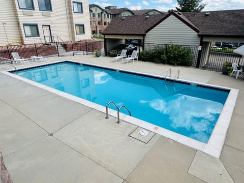 Large pool area with lounge seating, dining and grilling area.