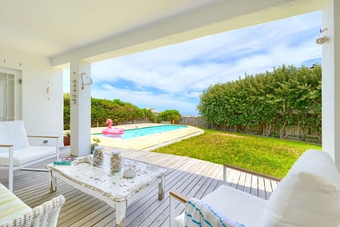 Verandah, pool, garden with trampoline leads directly onto the beach