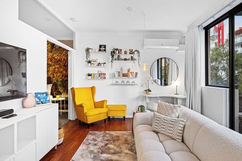 Explore a beautifully curated corner of this home, where a chic setup with a round mirror is complemented by artfully arranged shelves, creating a perfect blend of style and functionality.