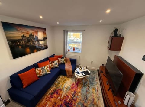 A bright and welcoming space with comfortable seating and a TV, perfect for relaxing after a day out.