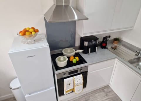 Fully equipped with stove, oven, microwave, fridge-freezer, dishwasher, toaster, blender, coffee maker, and cookware for home-style meals.