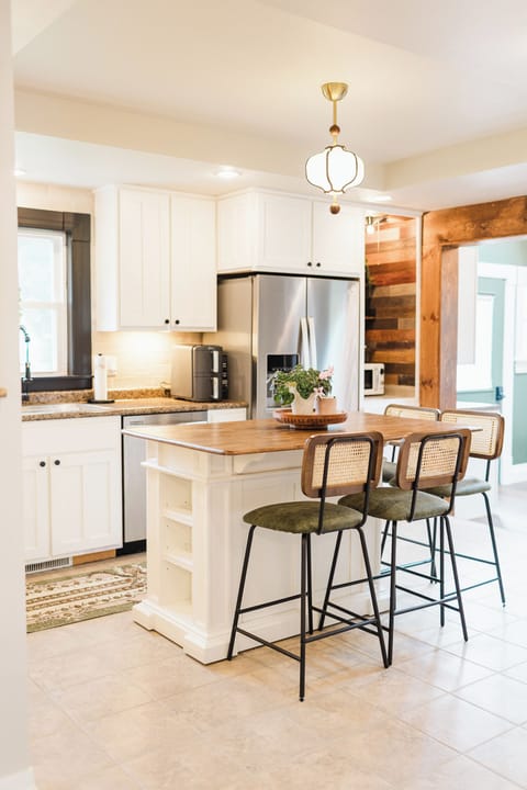A kitchen that brings everyone together. With its warm wood accents, central island seating, and modern appliances, this bright and inviting space is perfect for morning coffee, late-night snacks, and everything in between.