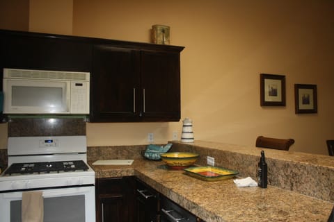 Fully equipped kitchen with gas burners, large refrigerator & spacious prep area