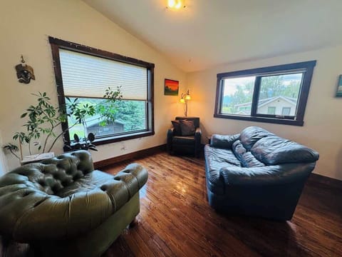 Kick back in the living room with big windows and natural light