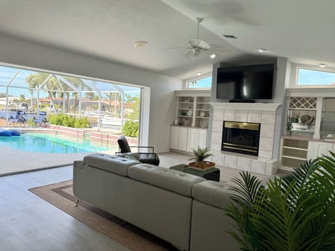 Spacious and comfortable seating in the living room overlooking the pool 

