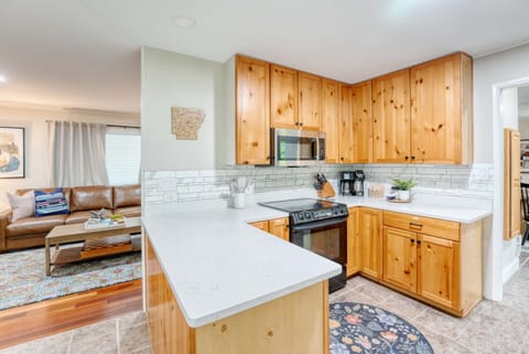 The rich texture of wooden cabinets paired with the sleek elegance of a stainless steel refrigerator creates an inviting atmosphere that enhances both functionality and style.