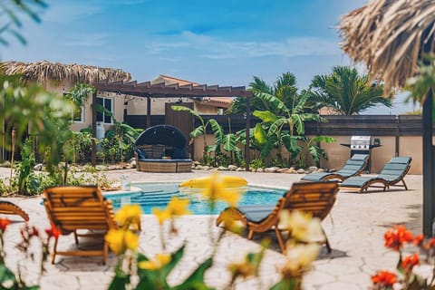 Poolside loungers with lush landscaping – a tranquil spot to enjoy the sun and unwind.

