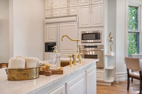 A large Chef's kitchen with SubZero refrigerator, hand pounded brass sink, 36" Gas range, 2 Ovens, Coffee Bar and Breakfast nook overlooking the gardens