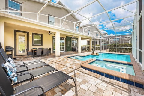 Private screened pool and spa with lounge area, perfect for relaxing under the Florida sun.
