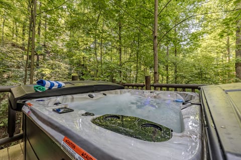 Enjoy ultimate relaxation in the spacious outdoor hot tub, nestled among the vibrant greenery of the surrounding trees, offering a private and serene escape. It's the perfect spot to unwind and soak in nature's beauty after a day of adventures.