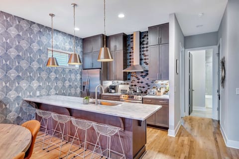 Welcome to this chic kitchen, perfect for hosting memorable meals! Gather at the stylish bar for snacks at your bachelorette party or family reunion. This downtown Nashville rental blends comfort and elegance for an unforgettable Music City experience!