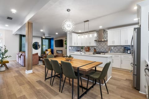 Open-concept main floor, connecting the modern kitchen, dining, and living areas seamlessly.