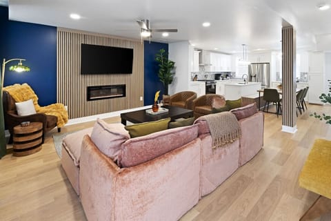 Cozy living room featuring a plush sofa, smart TV, and an inviting electronic fireplace.