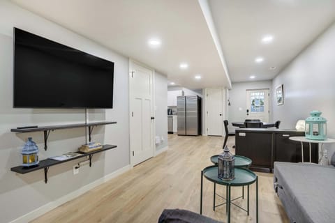 Open-concept living space with Smart TV, modern furnishings, and easy flow into the kitchen and dining area.

