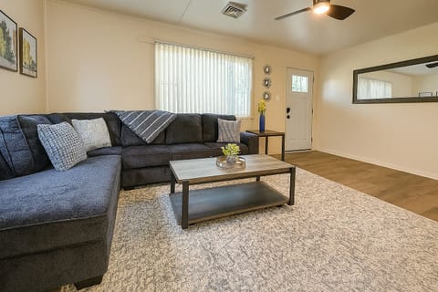 Living Room with Sectional Sofa, Ceiling Fan, side table, Smart TV & Coffee Table