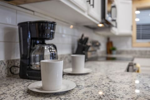 Brew your perfect morning coffee or whip up dinner with ease in this kitchen featuring granite counters and top-tier essentials.