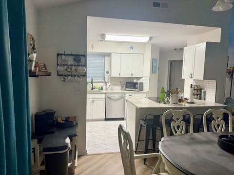 Dining area with four stools at the peninsula.