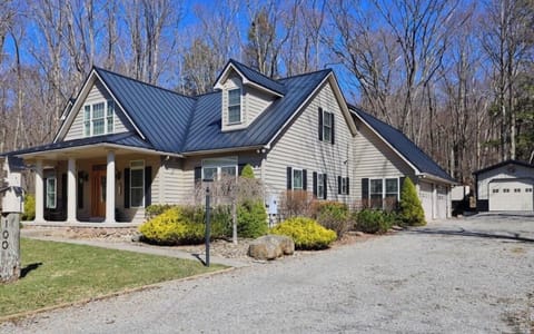 side driveway with attached  garage and single garage with Beach chairs and toys