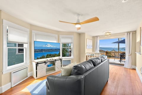 Living Room with 65in TV, pullout couch, wood deck, water views