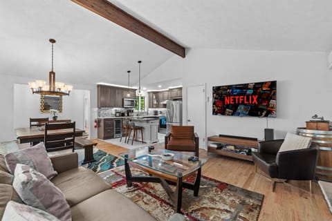 Cozy living room with large TV, electric fireplace, and plush seating—perfect for movie nights
