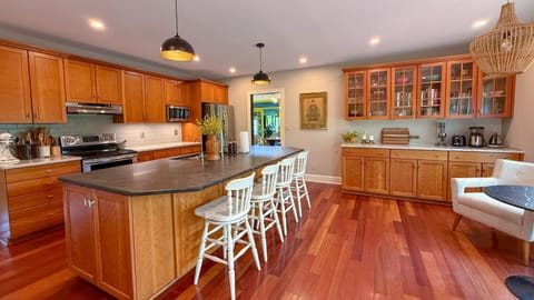 Start your day with coffee at the cozy breakfast table in the kitchen overlooking the backyard deck.