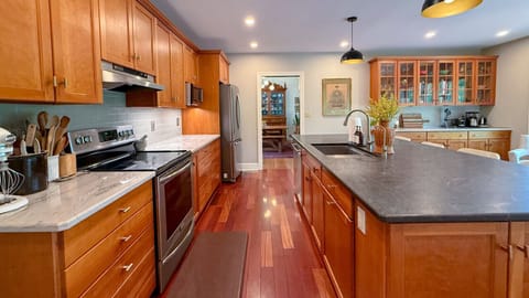 This spacious kitchen is fully stocked and ready for you—complete with island, appliances, and cooking essentials.