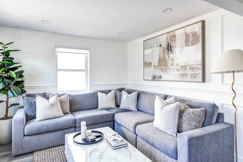 Settle into the spacious living room, complete with a cozy L-shaped sofa, stylish accents, and serene views—ideal for a peaceful break after your city adventures.