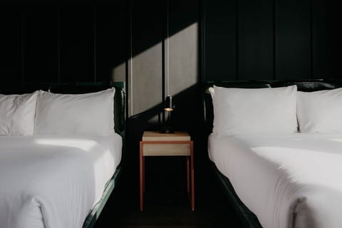 Sink into crisp linens between twin beds and soft light.