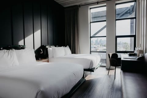 Wake up to skyline views beside bright windows and desks.