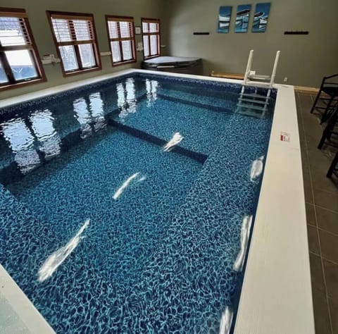 Indoor pool and hot tub. The pool depth is between 3 and 5 feet.