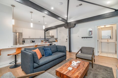 Unit 1: Open-concept living area featuring cozy furnishings, smart TV, and a sleeper sofa.