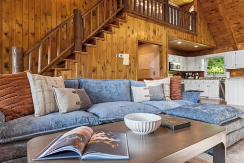 Unwind in the living room where you can cozy up by the warm indoor fireplace, enjoy your favorite shows on the Smart TV, and take in breathtaking views through the expansive windows. 