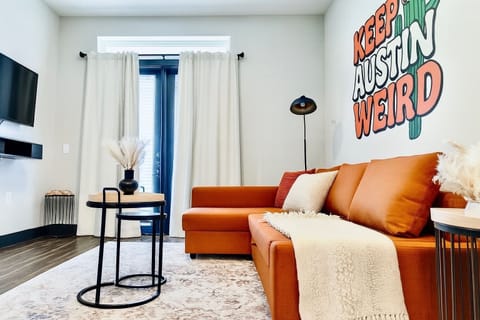 Cozy living room, with 55" TV, Black out curtains, and pull out queen sofa couch