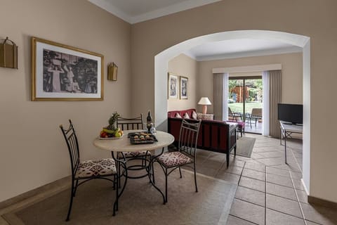 Sip wine at the dining table in calm, airy light.