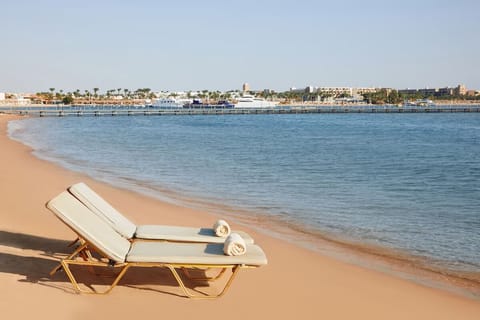 Bask on soft sand with tranquil sea views ahead.