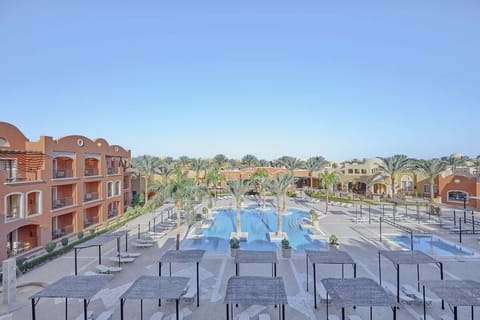 Bask in open skies above expansive, palm-lined pools.