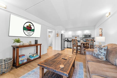 Open floor plan includes a living area with a sleeper sofa, streaming-capable TV, various board games, a fully equipped kitchen, a bedroom, and a bathroom, Creek View.