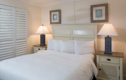 Recharge in crisp linens framed by serene coastal decor.