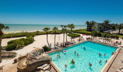 Dive into the sparkling pool with beach views beyond.
