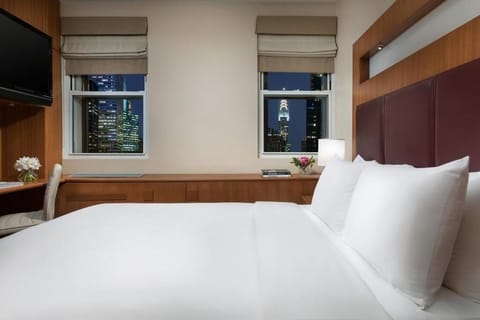 Unwind with sparkling skyline views as the city lights glow.